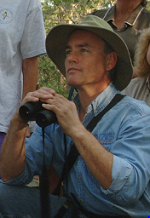 photo of Dr. Martin Main working in the field, observing wildlife with binoculars